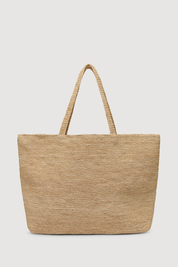 A natural woven straw tote bag with two top handles, shown against a solid white background.