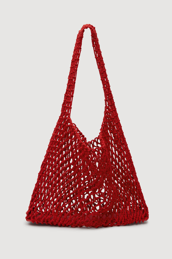 A bright red crocheted shoulder bag with a single long strap, shown against a plain white background.